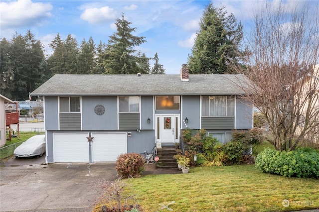 bi-level home with a front yard and a garage