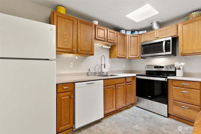 kitchen with sink, stainless steel appliances, and a skylight