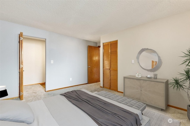 carpeted bedroom with a closet and a textured ceiling