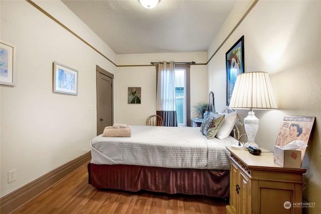 bedroom with hardwood / wood-style floors