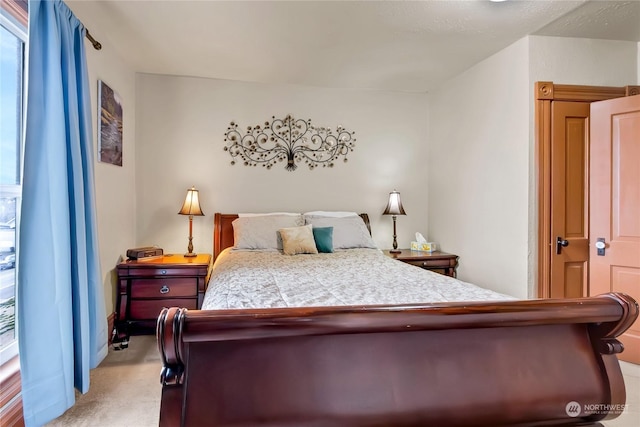 bedroom with light colored carpet