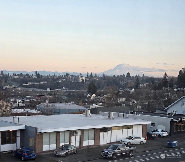 parking at dusk featuring a mountain view