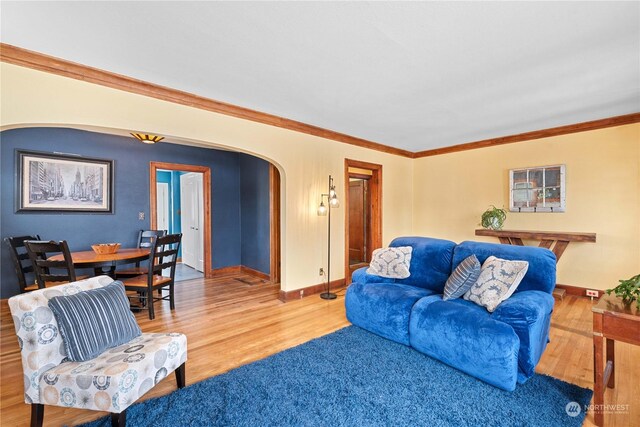 living room with hardwood / wood-style flooring and crown molding