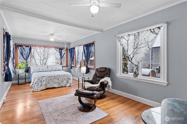 bedroom with ceiling fan, ornamental molding, and hardwood / wood-style flooring