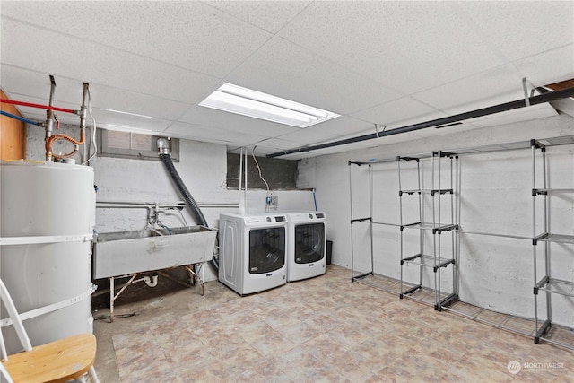 laundry room with water heater, sink, and washer and dryer