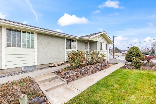 view of side of property with a lawn