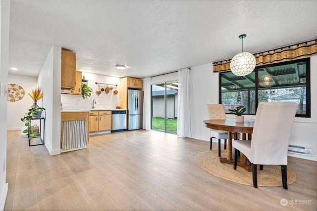 dining area featuring light hardwood / wood-style floors and sink