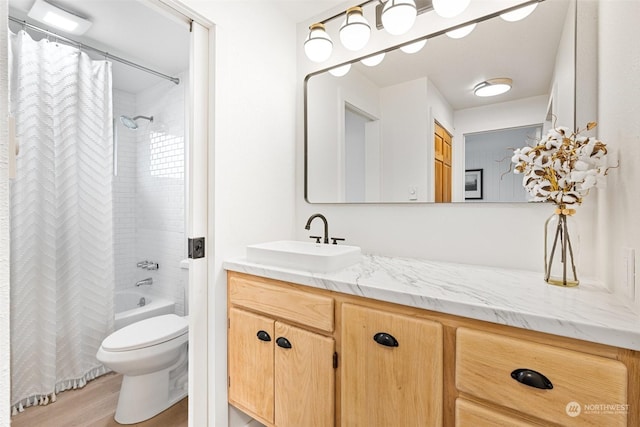 full bathroom with toilet, hardwood / wood-style flooring, vanity, and shower / bath combo with shower curtain