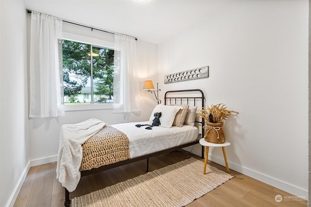 bedroom with light hardwood / wood-style floors