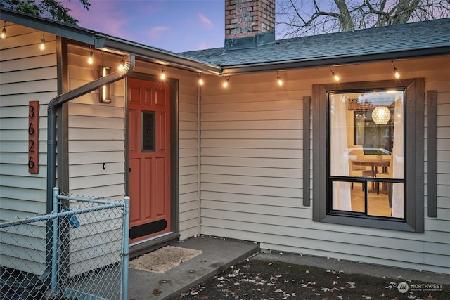 view of exterior entry at dusk