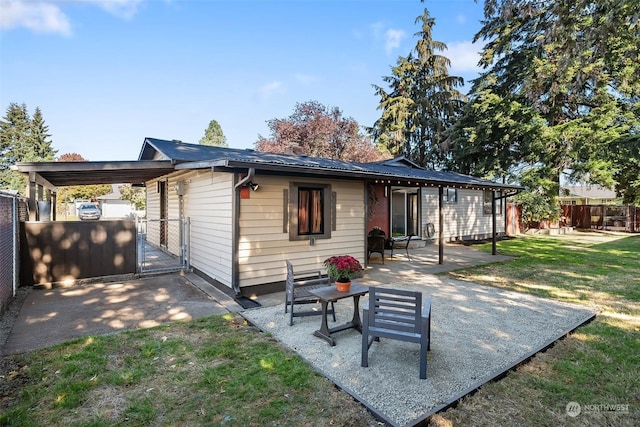 rear view of property with a yard and a patio