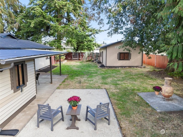 view of yard featuring an outdoor structure and a patio