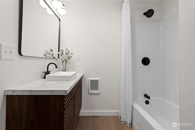 bathroom featuring hardwood / wood-style flooring, vanity, and shower / bath combo with shower curtain