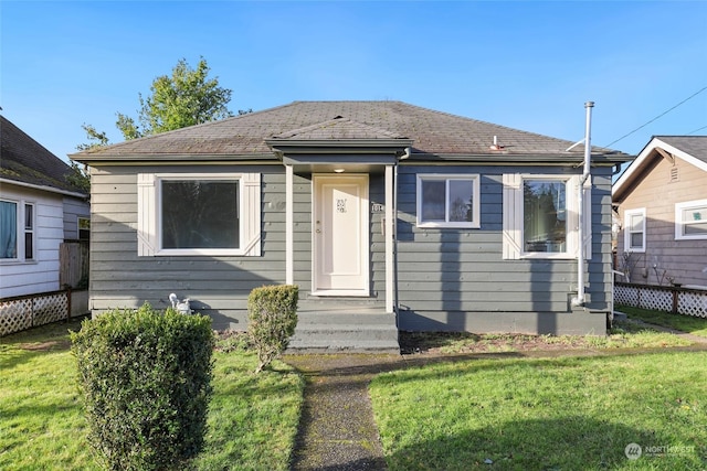 bungalow-style house with a front yard