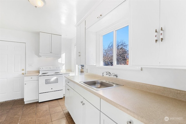 kitchen with electric stove, sink, white cabinets, and light tile patterned floors