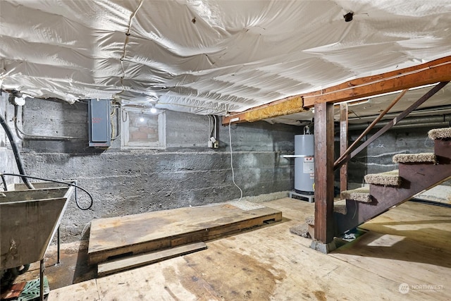 basement featuring electric panel and water heater