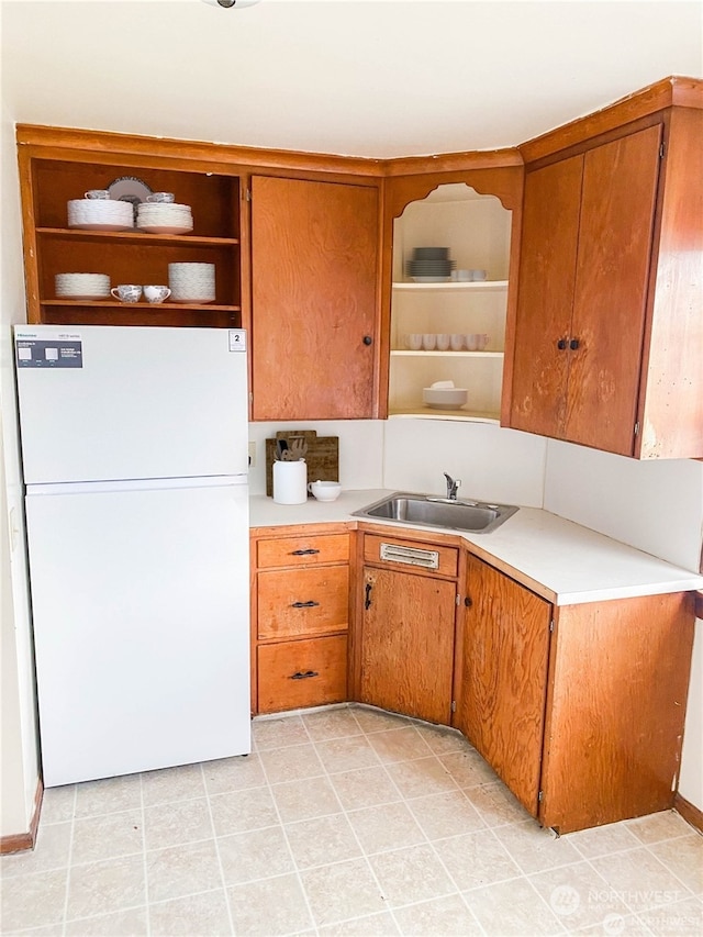 kitchen featuring white refrigerator and sink