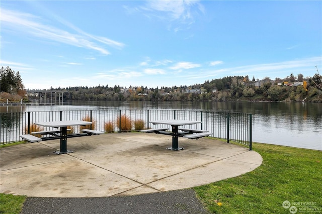 view of dock with a patio area and a water view