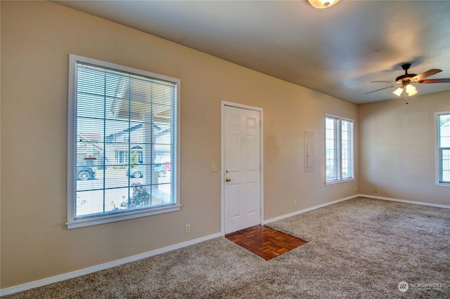 entryway featuring ceiling fan, plenty of natural light, and parquet floors