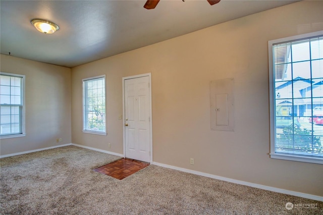 entrance foyer featuring ceiling fan, a wealth of natural light, parquet flooring, and electric panel