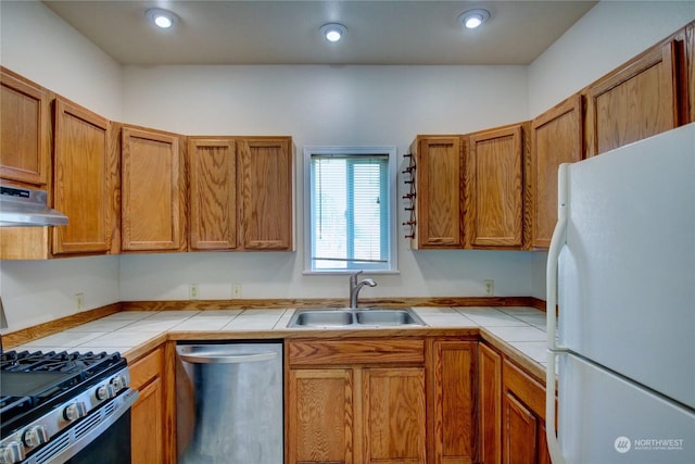 kitchen featuring tile counters, sink, and stainless steel appliances