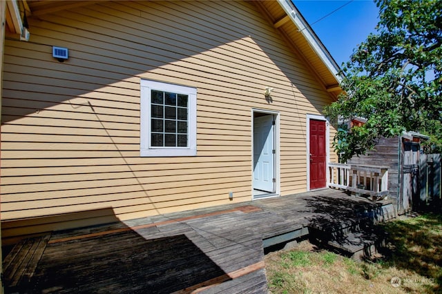 view of side of property with a wooden deck