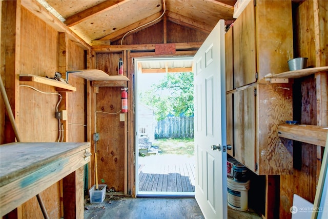 doorway to outside featuring lofted ceiling