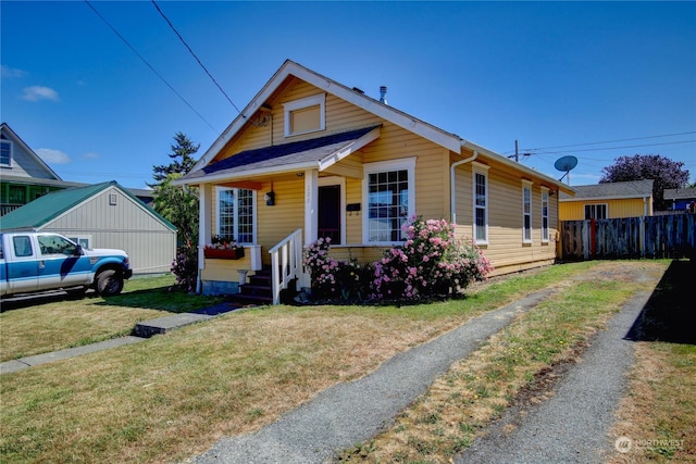 bungalow-style house featuring a front yard