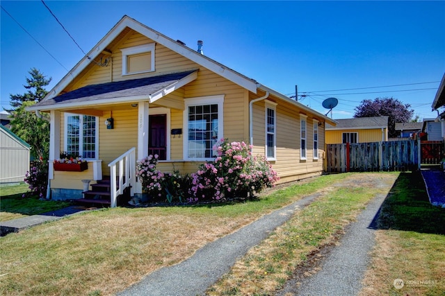 bungalow-style home with a front yard