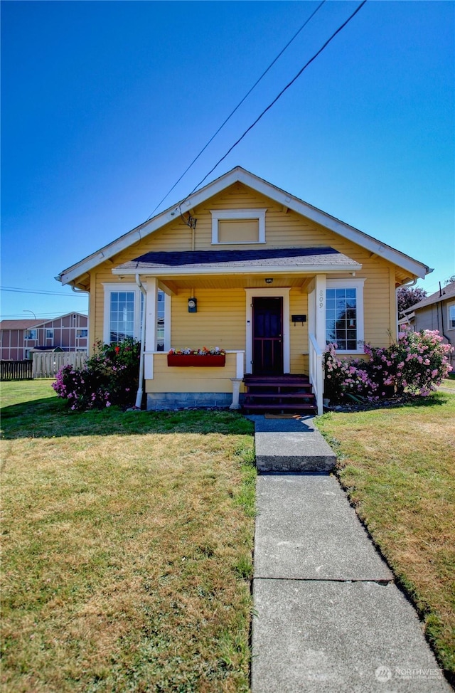 view of front of home with a front lawn and covered porch