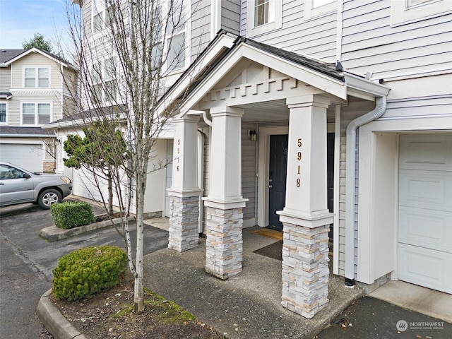 view of exterior entry with a garage