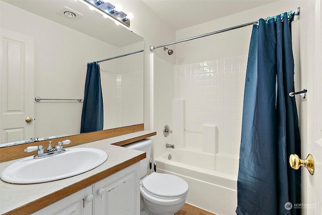 full bathroom with shower / bath combination with curtain, vanity, and toilet