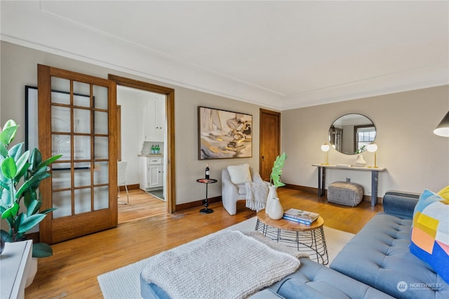 living room with hardwood / wood-style floors, french doors, and crown molding