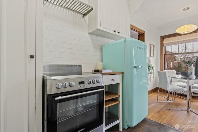 kitchen featuring white cabinets, white refrigerator, electric stove, dark hardwood / wood-style floors, and tasteful backsplash