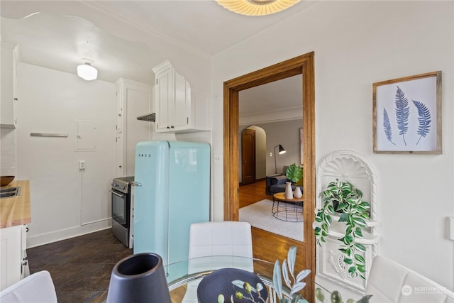 dining space featuring ornamental molding and dark wood-type flooring