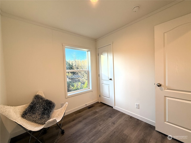 unfurnished room featuring dark wood-type flooring and crown molding