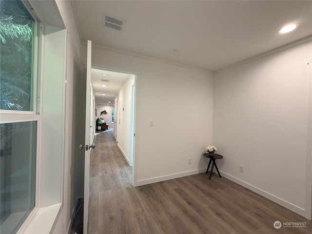 unfurnished room featuring wood-type flooring and crown molding