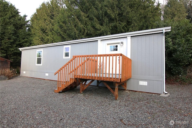 rear view of house with a wooden deck