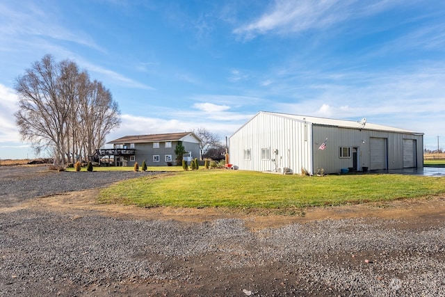 view of outbuilding with a yard and a garage