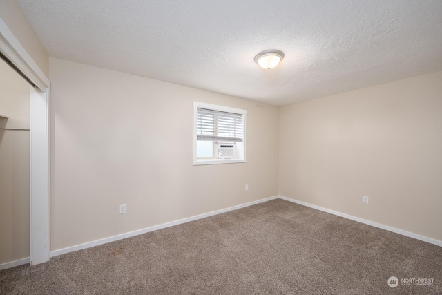 carpeted spare room with a textured ceiling