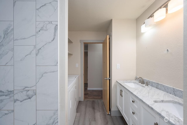 bathroom with vanity, a textured ceiling, and hardwood / wood-style flooring