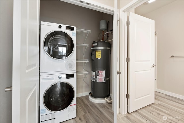 laundry area featuring light wood-type flooring, stacked washer / dryer, and water heater