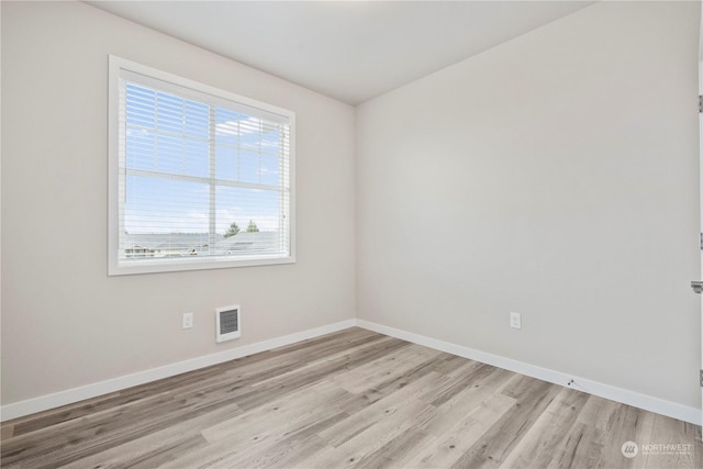 unfurnished room featuring light hardwood / wood-style flooring and a healthy amount of sunlight