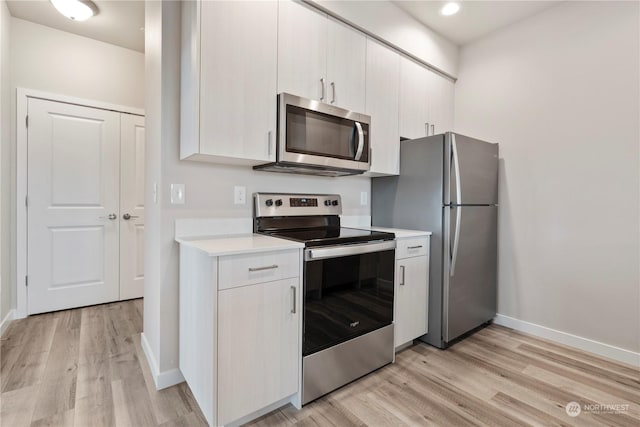 kitchen featuring appliances with stainless steel finishes and light wood-type flooring