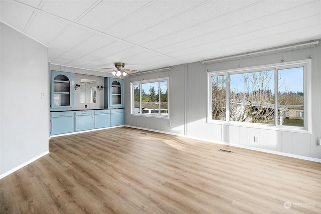 unfurnished living room featuring hardwood / wood-style floors and ceiling fan