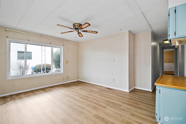 spare room with hardwood / wood-style floors and ceiling fan