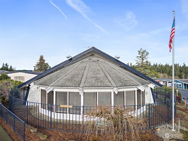 rear view of property with a sunroom