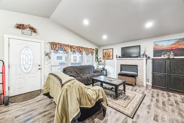 living room featuring vaulted ceiling and light wood-type flooring