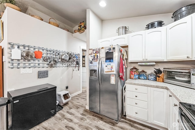 kitchen featuring light hardwood / wood-style floors, white cabinets, and appliances with stainless steel finishes