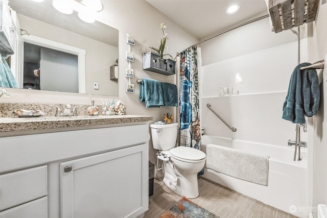 full bathroom with vanity, shower / tub combo with curtain, and toilet